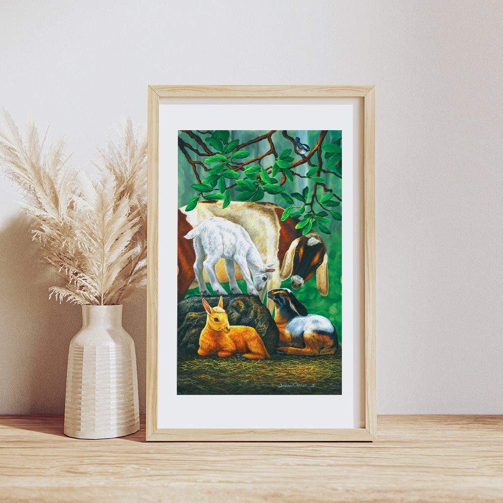 Goat Fam - Nubian Goat and Kids Art Print: A whimsical illustration showing a mother Nubian goat and three baby goat kids relaxing under a lush green madrone tree. The illustration is framed in light wood and white matte. 