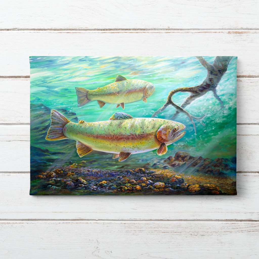 "Rainbow River" art print featuring vibrant rainbow trout swimming in turquoise Alaskan waters, with detailed scales and spotted patterns, gliding above a colorful rocky riverbed in dappled underwater light. By Jeanne Warren